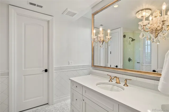 a bathroom with a sink vanity and a mirror