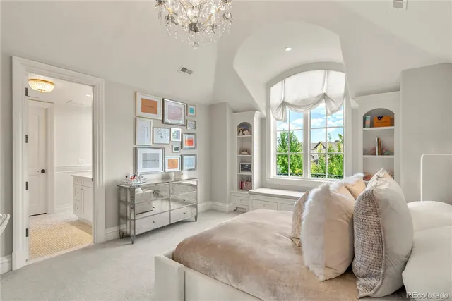 a spacious bedroom with a bed and ceiling fan