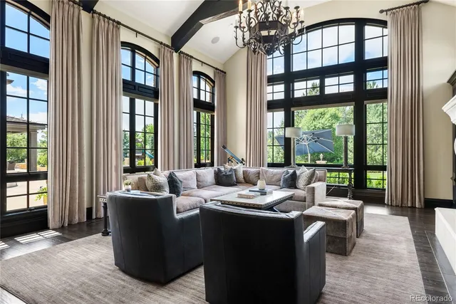 a living room with furniture and large windows