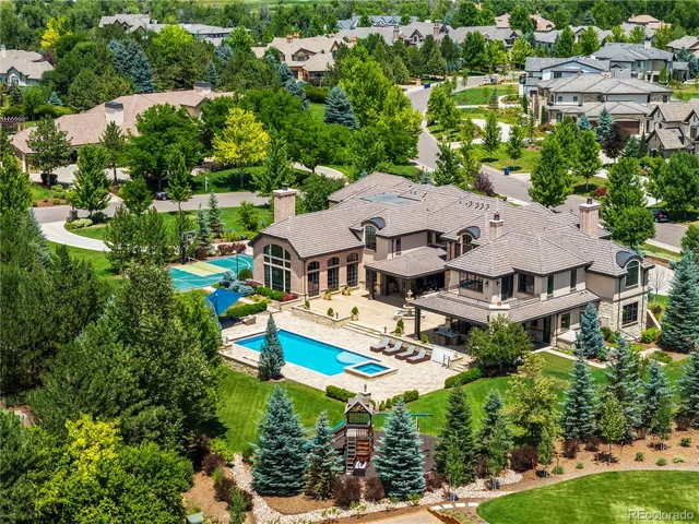 an aerial view of a house with swimming pool outdoor seating and yard