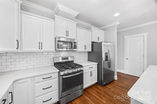 a kitchen with stainless steel appliances a refrigerator stove and sink