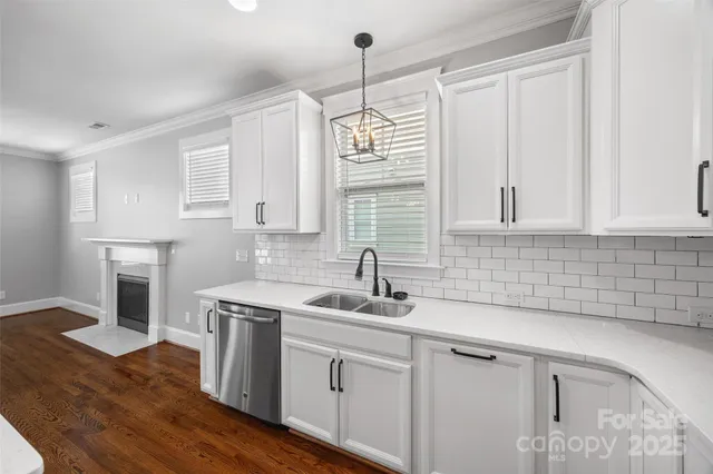 a kitchen with a sink cabinets and window