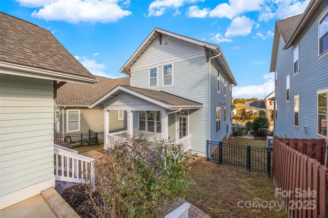 a front view of house with yard and trees around