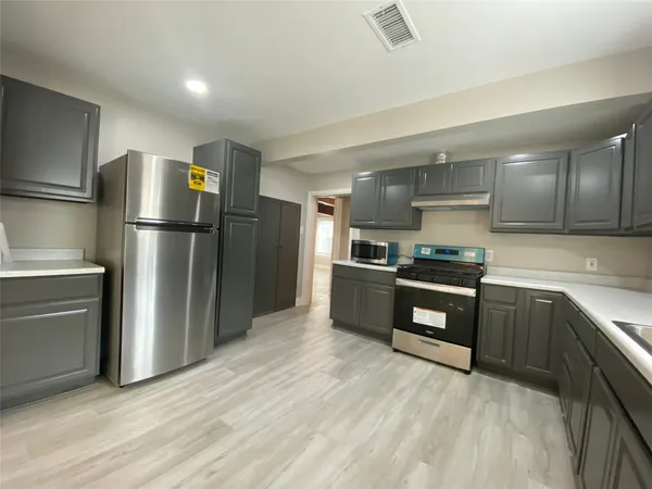 a kitchen with a refrigerator and a sink