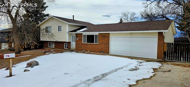 6313 Chippewa Road Colorado Springs, CO 80915 - Photo 2 of 36 Tri-level home with a garage