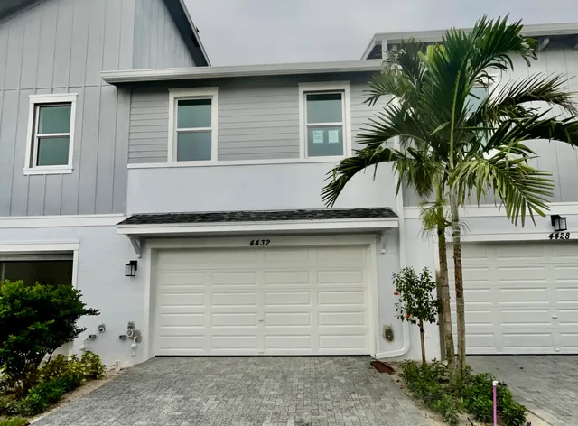 a front view of house with garage and yard
