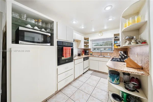 a kitchen with stainless steel appliances a microwave and a refrigerator