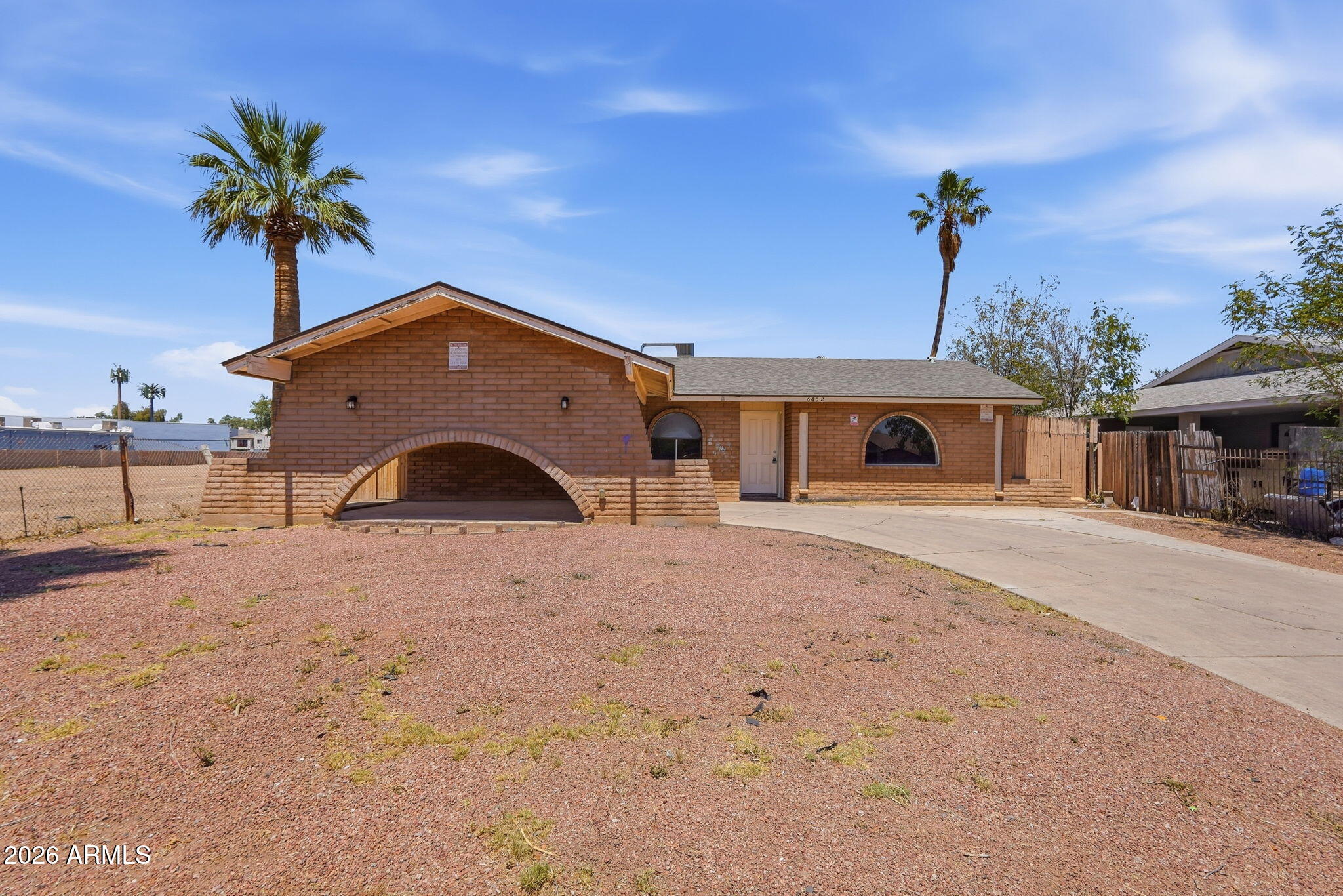 6452 West Thomas Road Phoenix, AZ 85033 - Photo 1 of 30 a front view of a house with a yard and garage