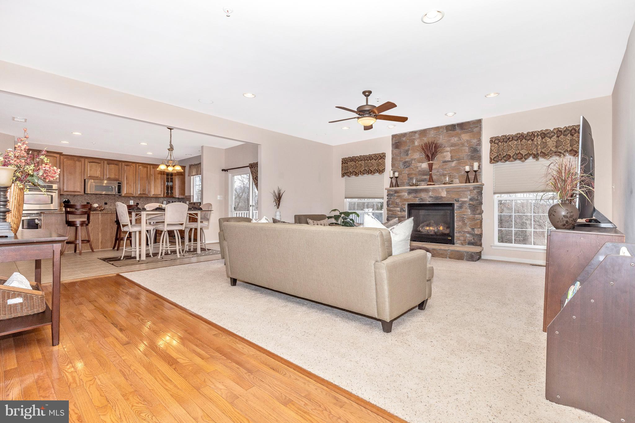 14513 Bubbling Spring Road Boyds, MD 20841 - Photo 11 of 57 a living room with furniture fireplace and kitchen view