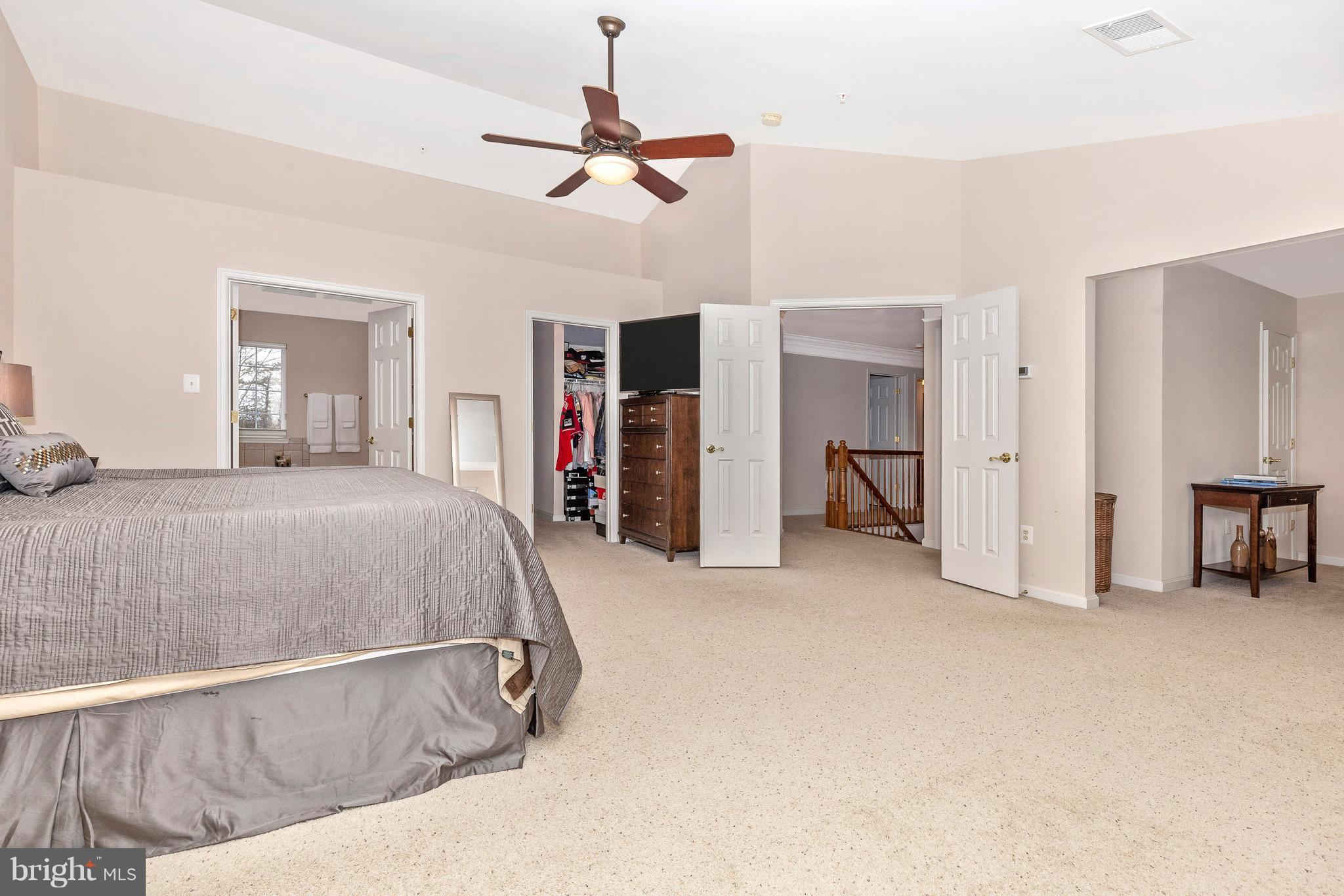 14513 Bubbling Spring Road Boyds, MD 20841 - Photo 24 of 57 a bedroom with a bed and a chandelier