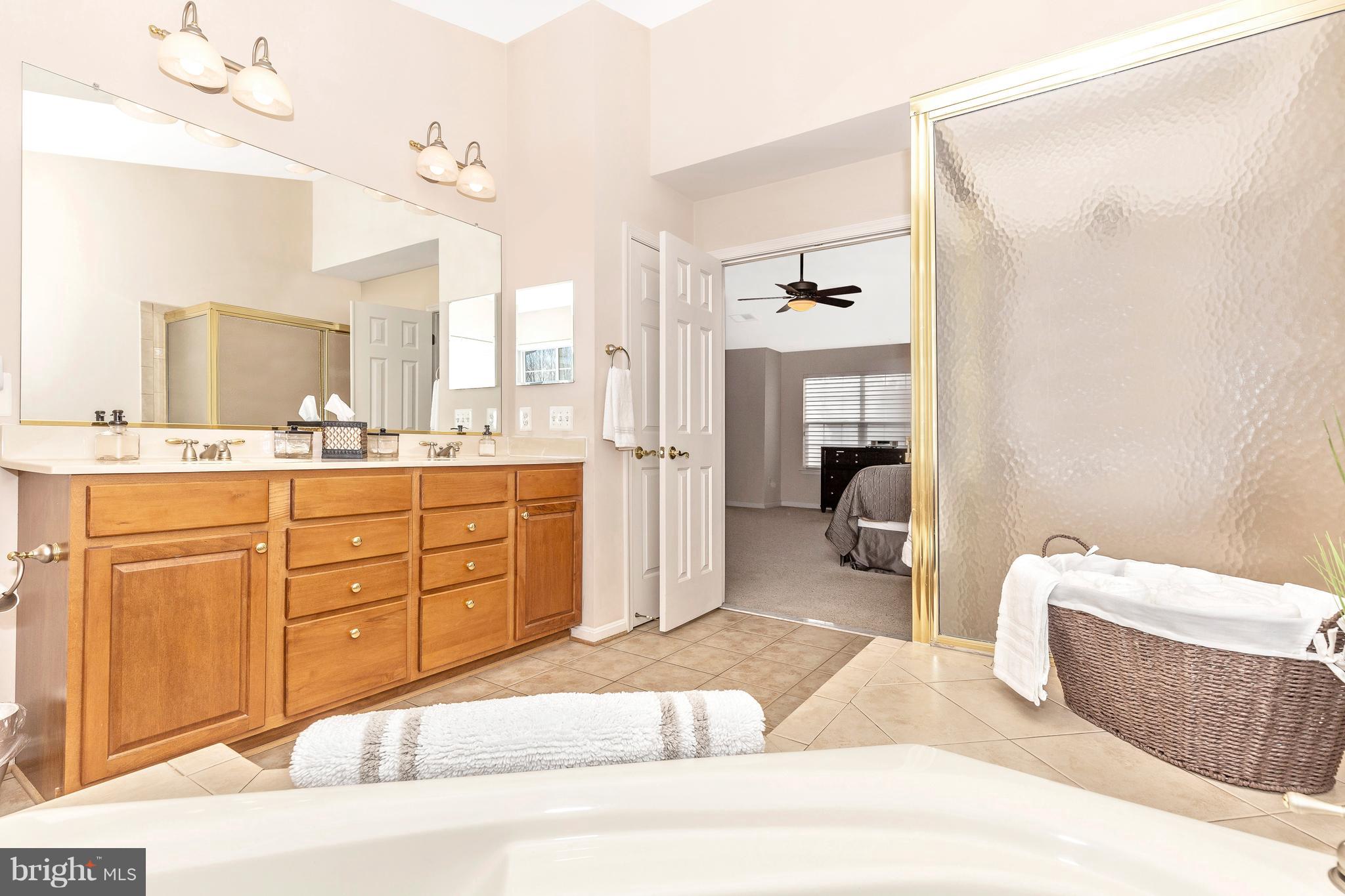 14513 Bubbling Spring Road Boyds, MD 20841 - Photo 27 of 57 a spacious bathroom with a granite countertop sink mirror and bathtub