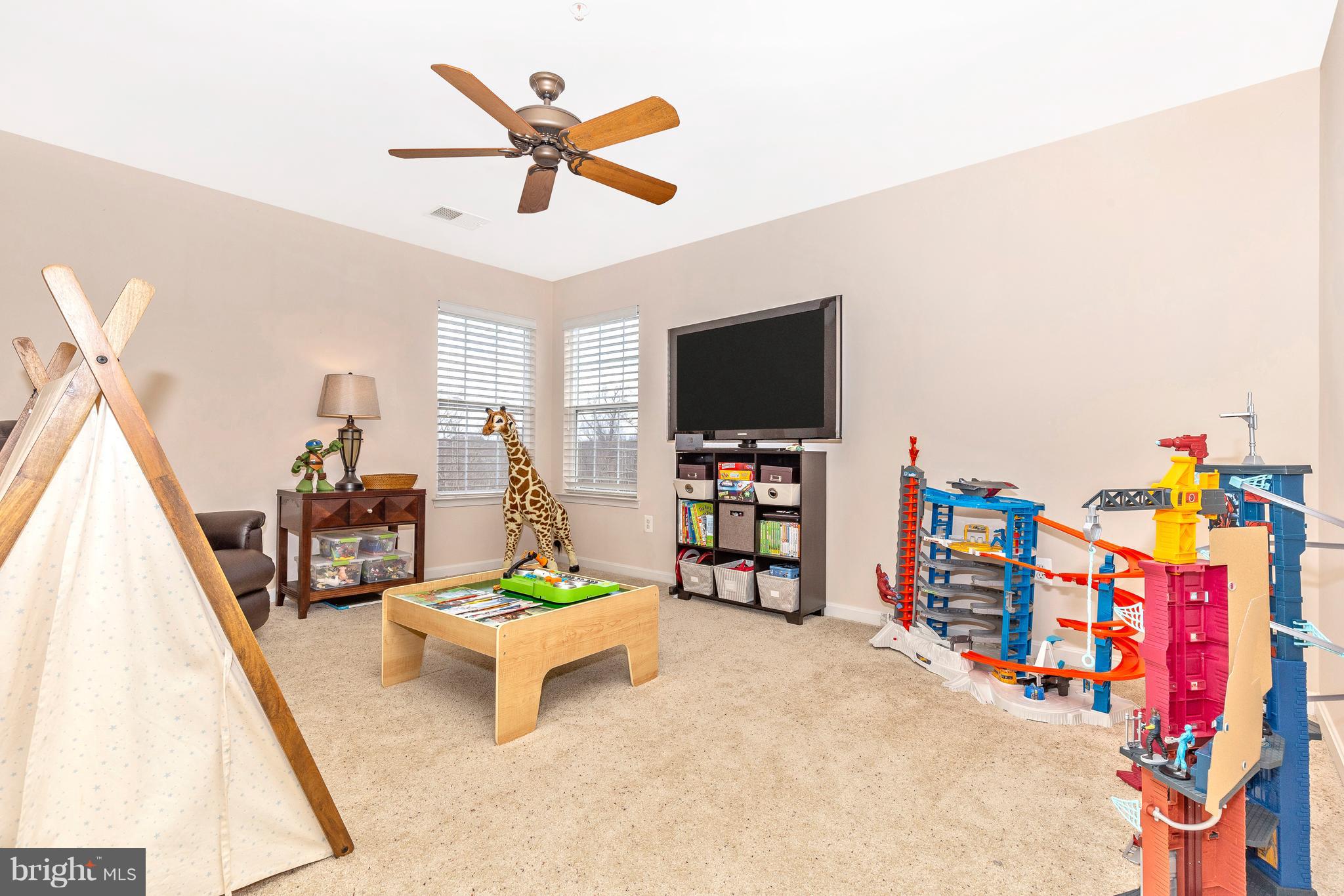 14513 Bubbling Spring Road Boyds, MD 20841 - Photo 30 of 57 a living room with furniture and a flat screen tv