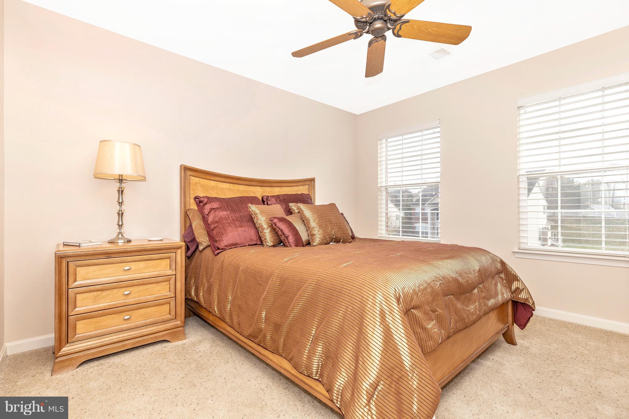 14513 Bubbling Spring Road Boyds, MD 20841 - Photo 31 of 57 a spacious bedroom with a bed and a chandelier