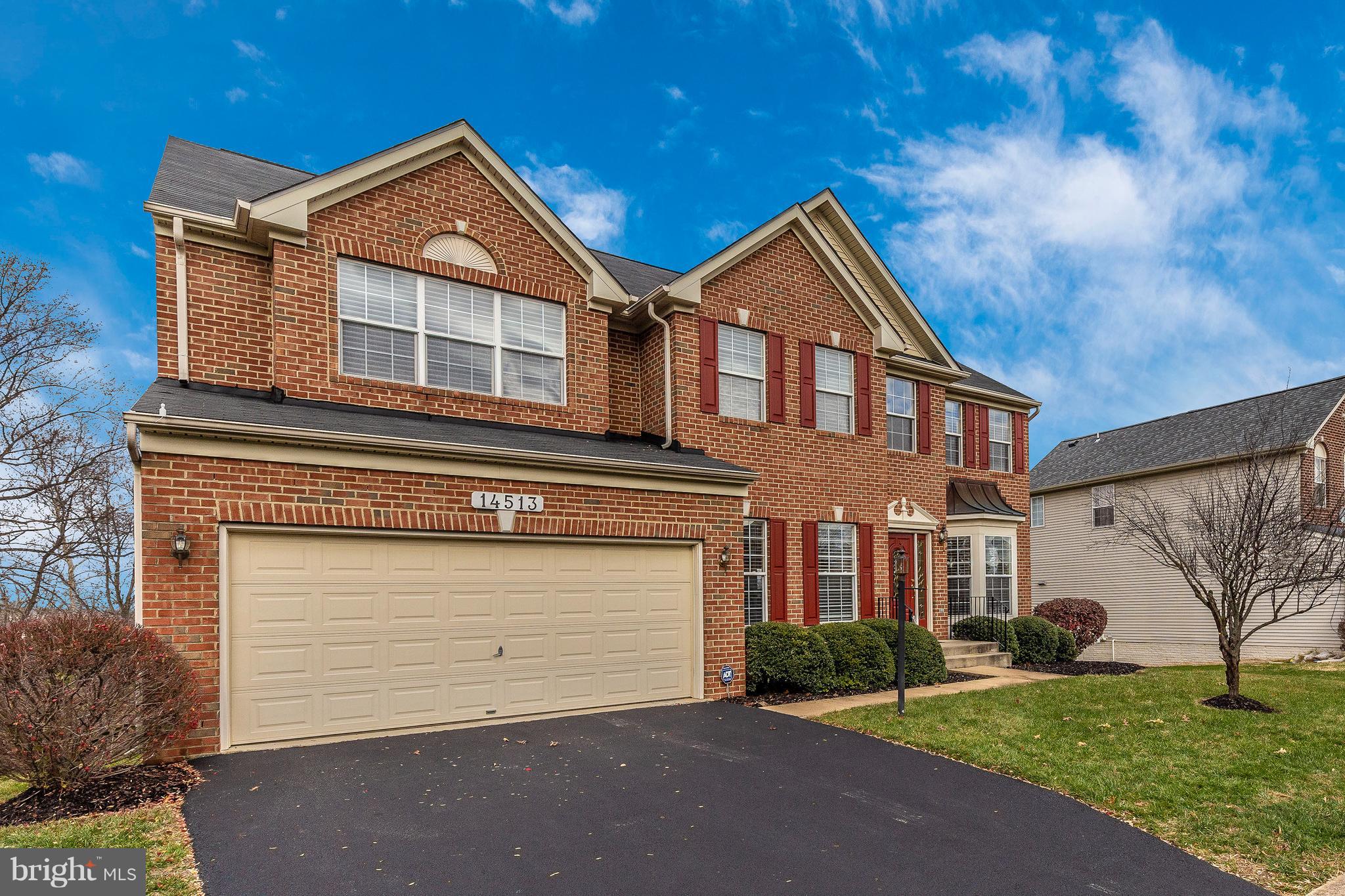 14513 Bubbling Spring Road Boyds, MD 20841 - Photo 41 of 57 a front view of a house with a yard and garage