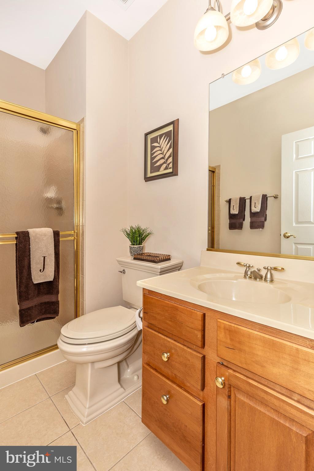 14513 Bubbling Spring Road Boyds, MD 20841 - Photo 7 of 57 a bathroom with a granite countertop toilet sink and mirror