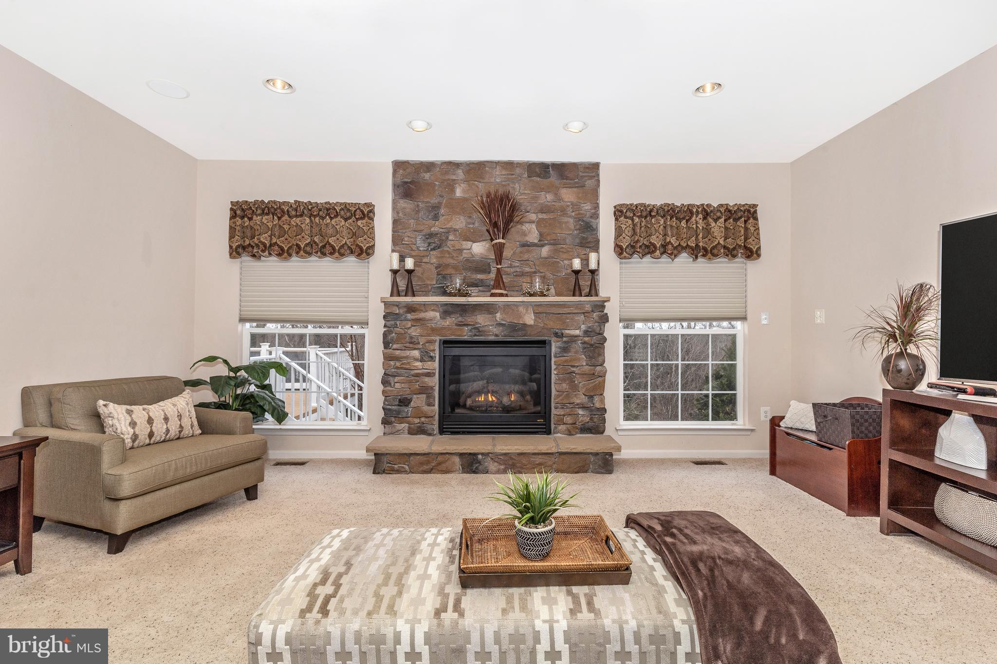 14513 Bubbling Spring Road Boyds, MD 20841 - Photo 9 of 57 a living room with furniture a window and a fireplace