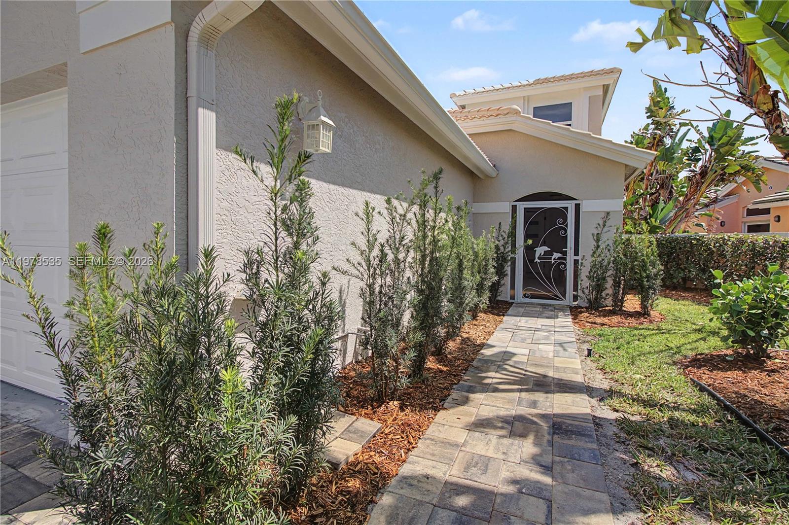 140 Eveningstar Cay Naples, FL 34114 - Photo 3 of 51 a view of a house with potted plants