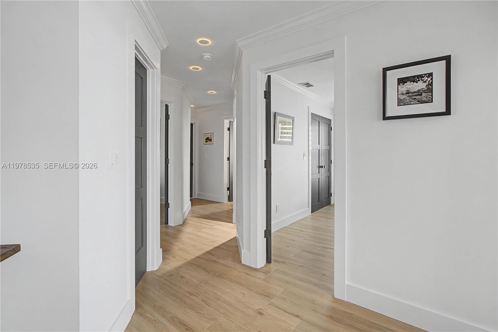 140 Eveningstar Cay Naples, FL 34114 - Photo 33 of 51 a view of a hallway with wooden floor