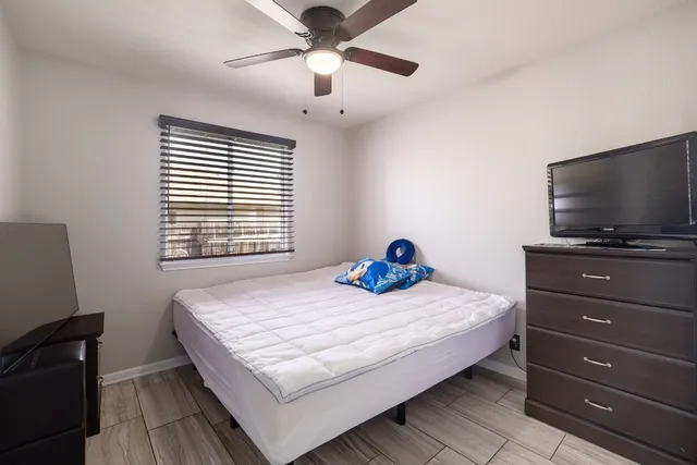 a bedroom with a bed and a flat screen tv