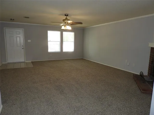 an empty room with a empty space and windows