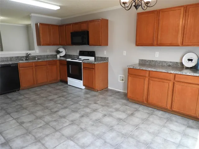 a kitchen with stainless steel appliances granite countertop a stove a sink dishwasher and a microwave oven on the blue kitchen countertops