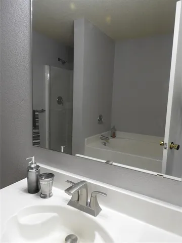 a bathroom with a tub and sink