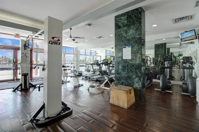 a living room with lots of furniture and a wooden floor