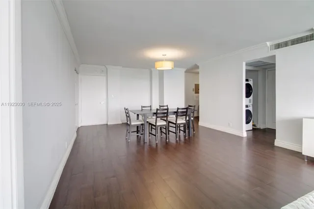 a view of a a dining room with furniture and wooden floor