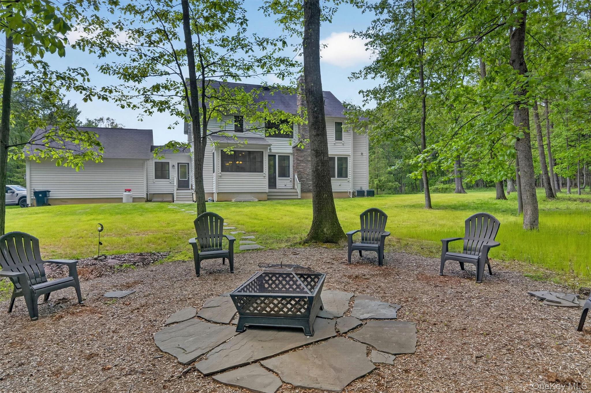 28 Bethlehem Road New Windsor, NY 12553 - Photo 48 of 50 a view of a swimming pool and lounge chairs in back yard of the house