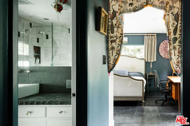 a living room with furniture large window and flat screen tv