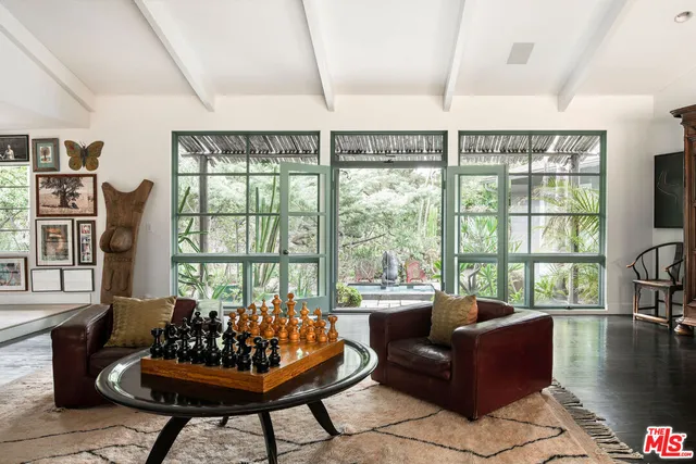 a living room with furniture and a book shelf