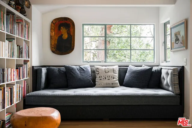 a bedroom with furniture and a flat screen tv