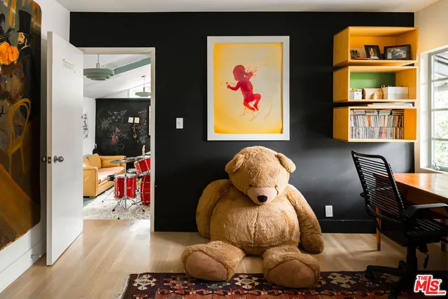 a living room with a couch and a potted plant