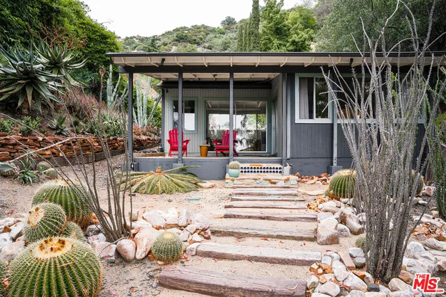 a living room with furniture a window and a flat screen tv