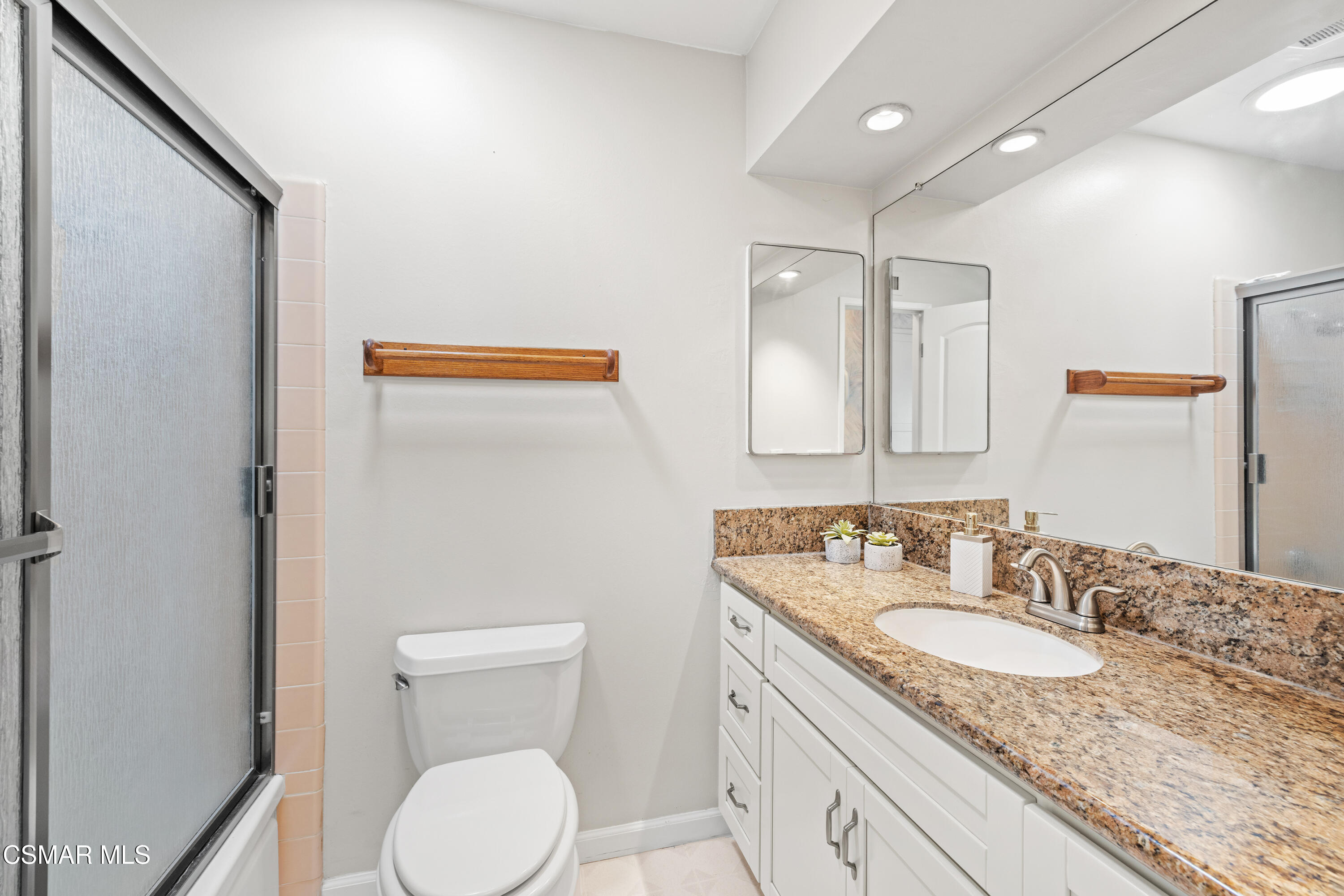 4477 Hempstead Street Simi Valley, CA 93063 - Photo 15 of 25 a bathroom with a granite countertop sink toilet and mirror