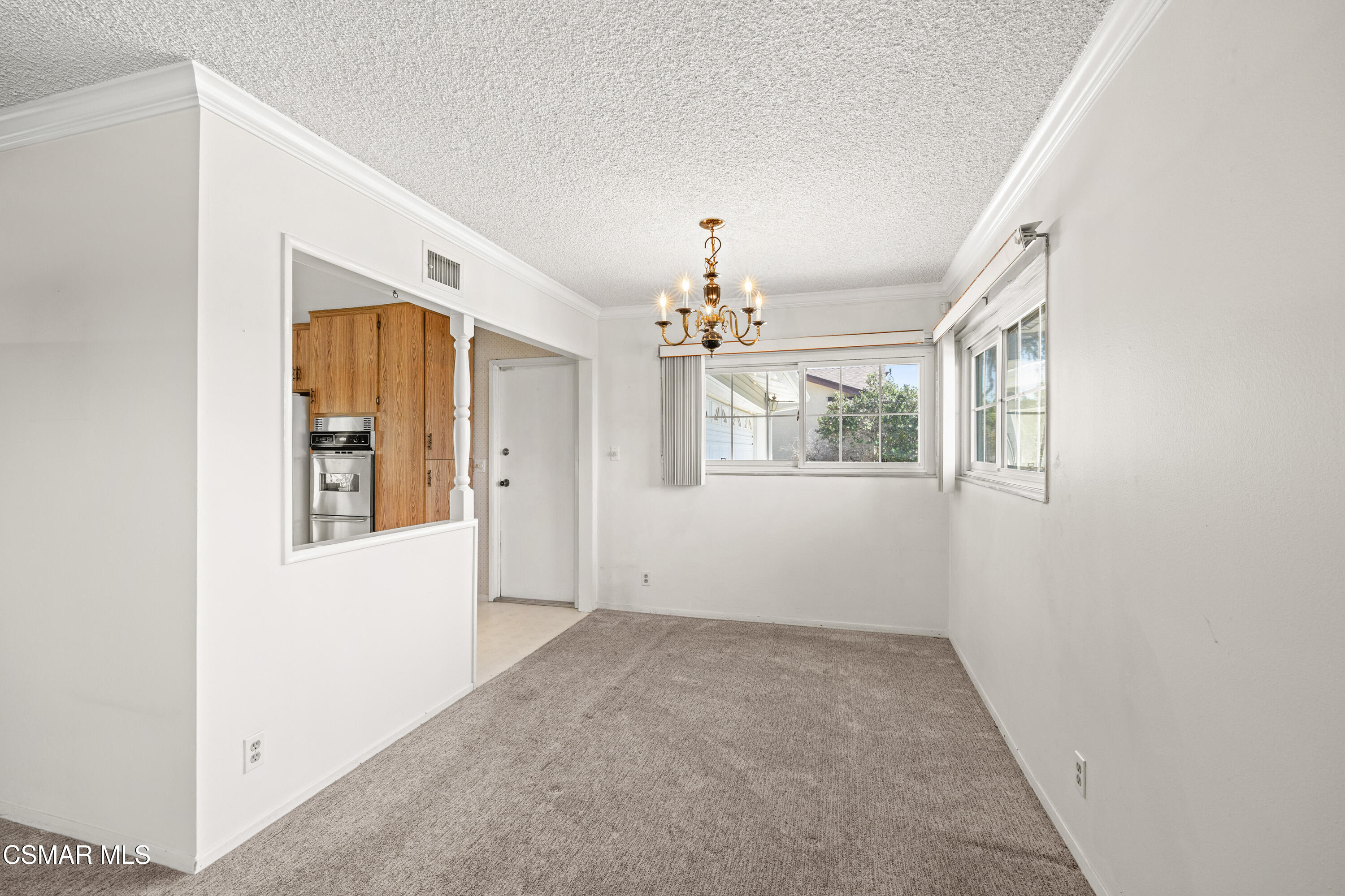 4477 Hempstead Street Simi Valley, CA 93063 - Photo 5 of 25 an empty room with windows and chandelier