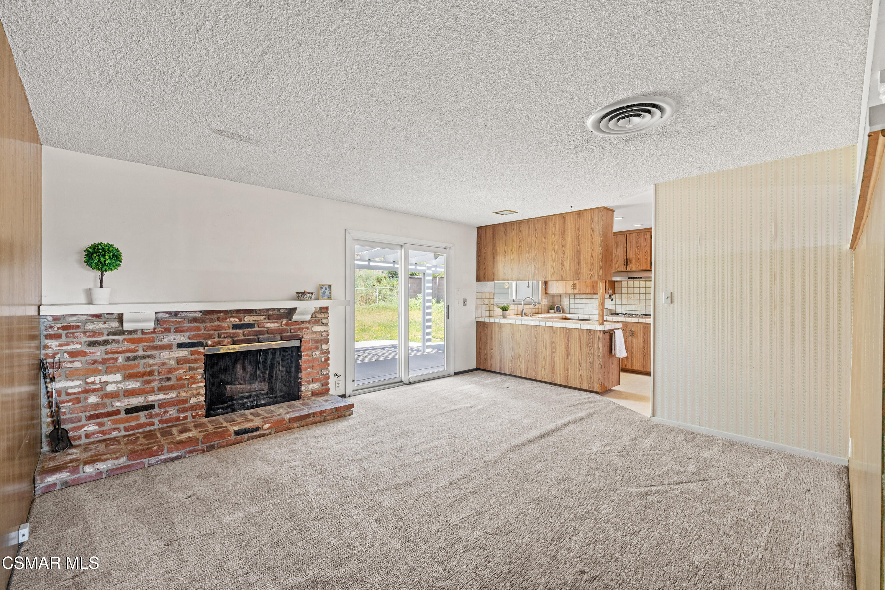 4477 Hempstead Street Simi Valley, CA 93063 - Photo 6 of 25 a view of a kitchen with furniture and a fireplace