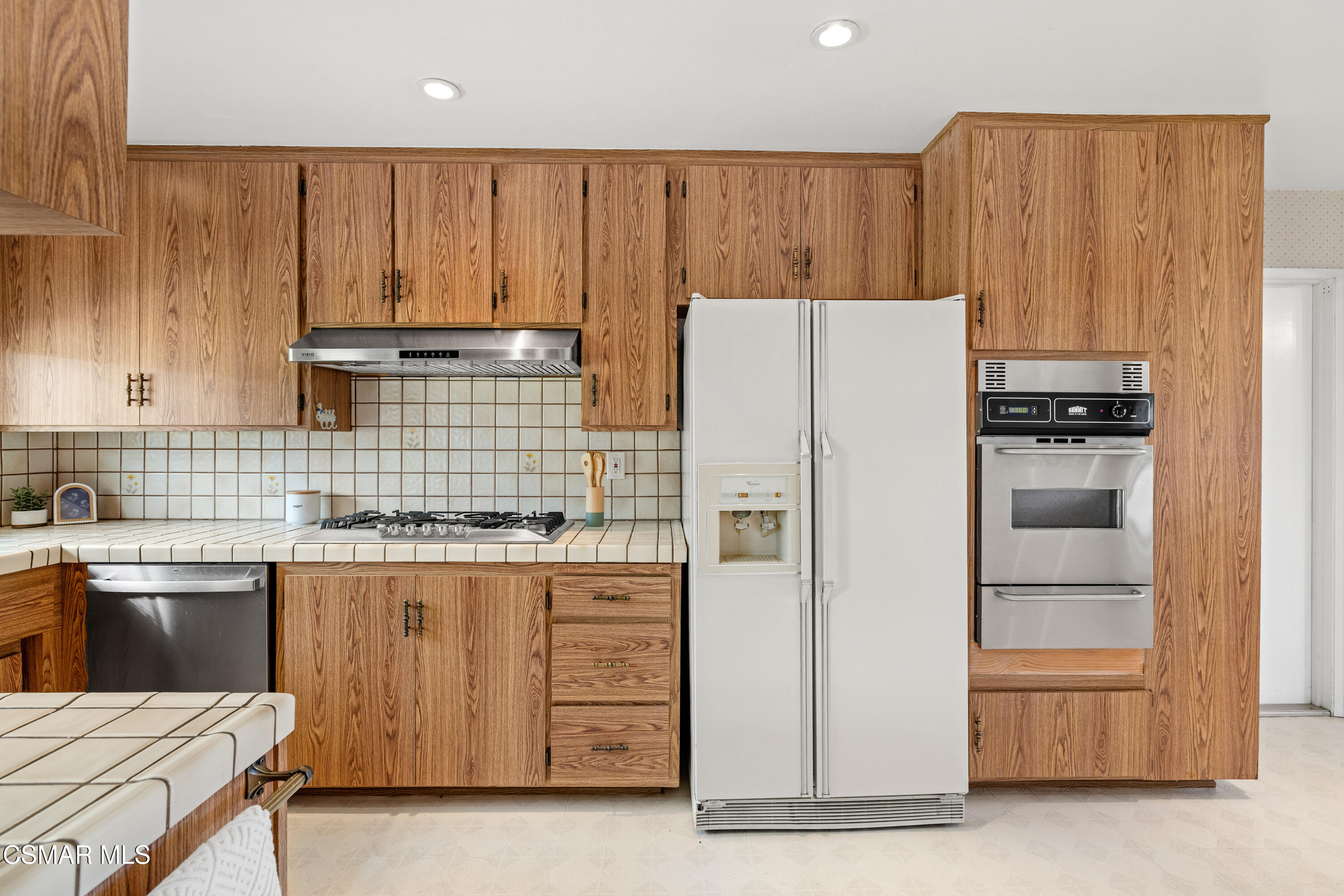 4477 Hempstead Street Simi Valley, CA 93063 - Photo 7 of 25 a kitchen with a cabinets and white appliances