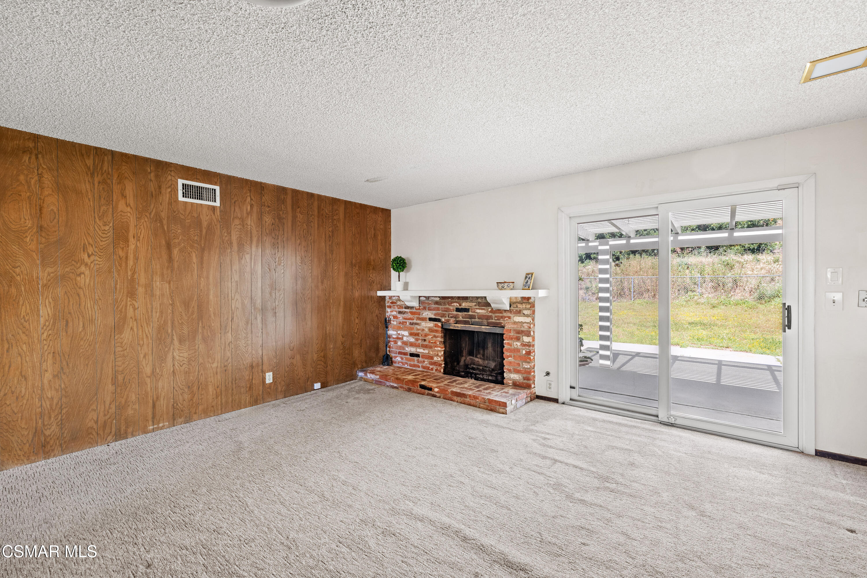 4477 Hempstead Street Simi Valley, CA 93063 - Photo 10 of 25 a view of an empty room with a fireplace and a window