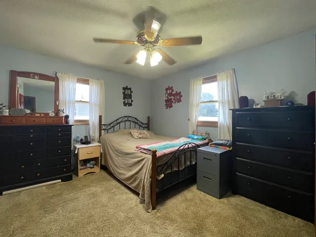 a bedroom with a bed and a dresser