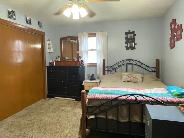 a bedroom with a bed and lamps