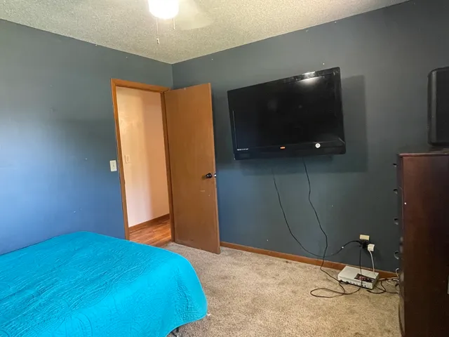 a bedroom with a bed and a flat screen tv