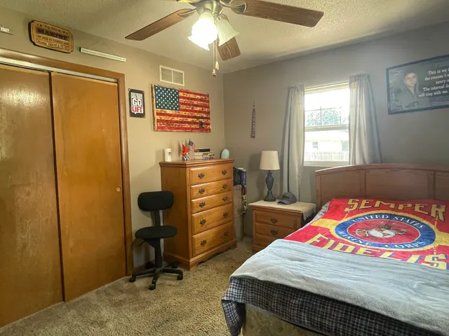 a bedroom with a bed and a dresser in it