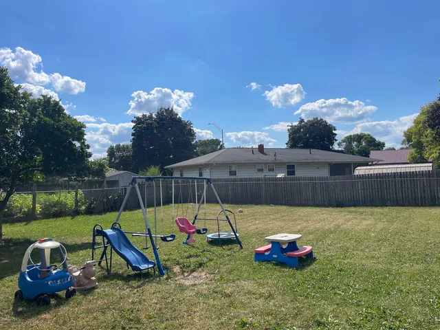 a view of a backyard with plants and outdoor seating