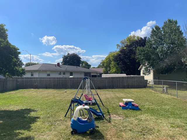 a view of a backyard with swimming pool