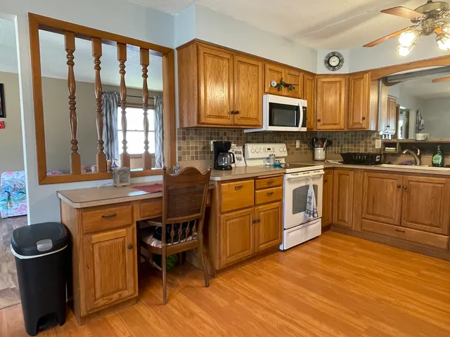 a kitchen with a sink stove and cabinets