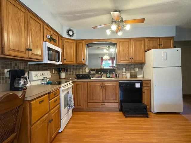 a kitchen with stainless steel appliances granite countertop a refrigerator sink and cabinets