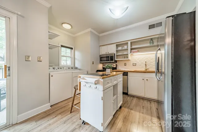 a kitchen with white cabinets and white appliances