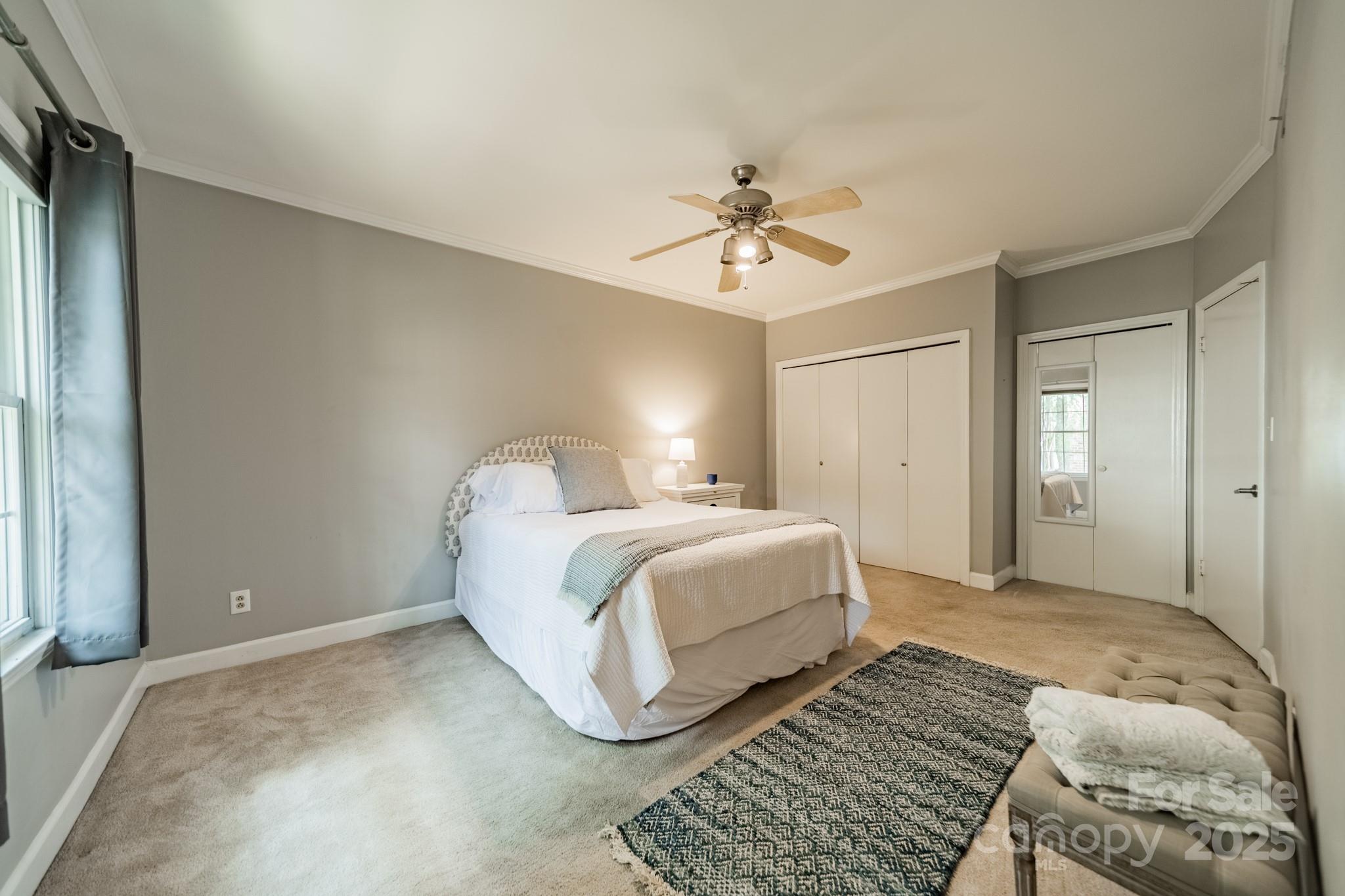 5927 Quail Hollow Road, Unit H Charlotte, NC 28210 - Photo 20 of 45 a spacious bedroom with a bed and a chandelier