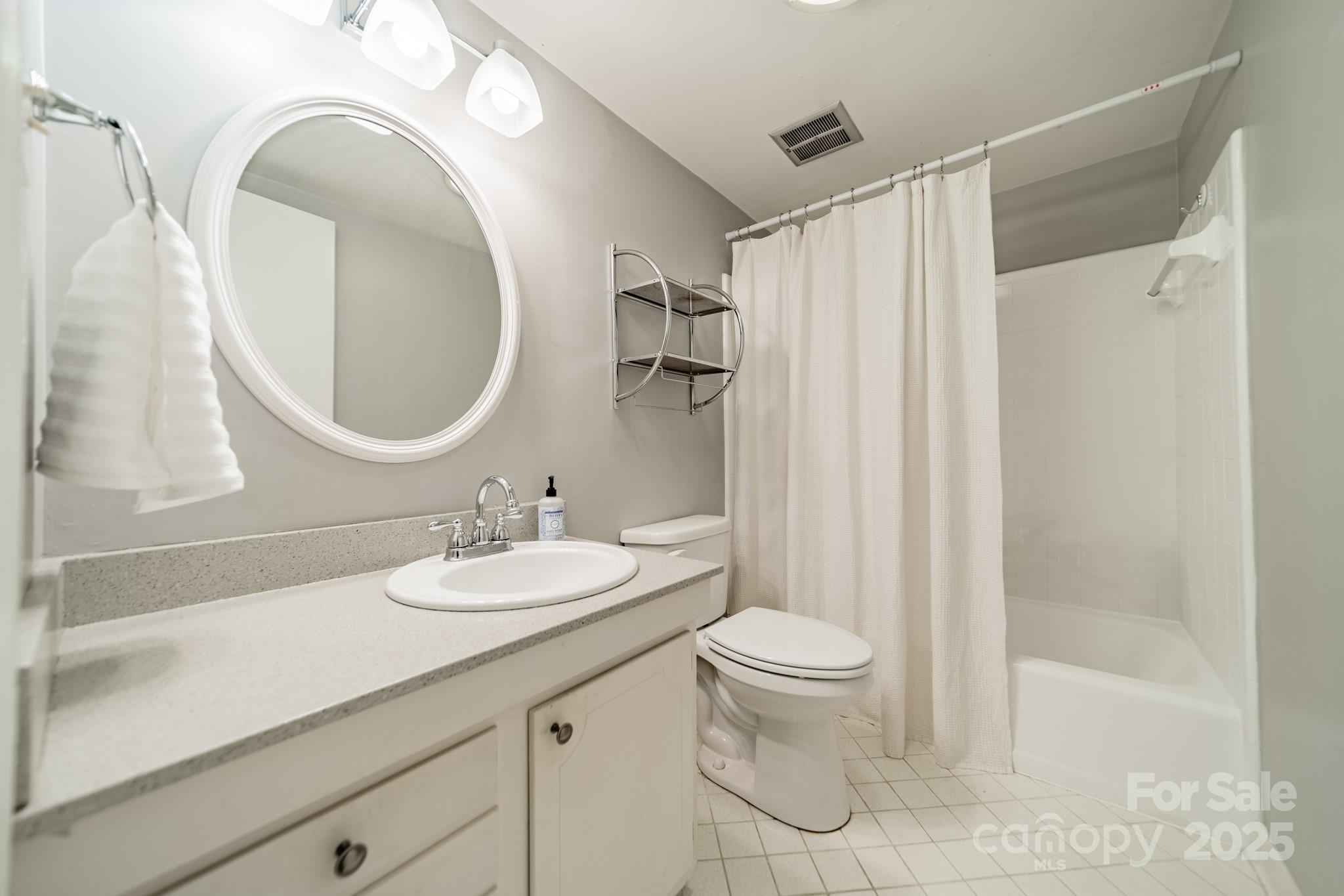 5927 Quail Hollow Road, Unit H Charlotte, NC 28210 - Photo 27 of 45 a bathroom with a sink a toilet and a mirror